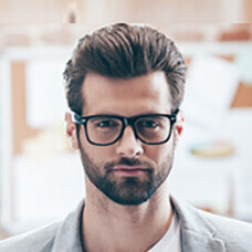 A bearded man wearing glasses